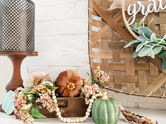 A farmhouse fall mantel with DIY projects and dollar tree pumpkins