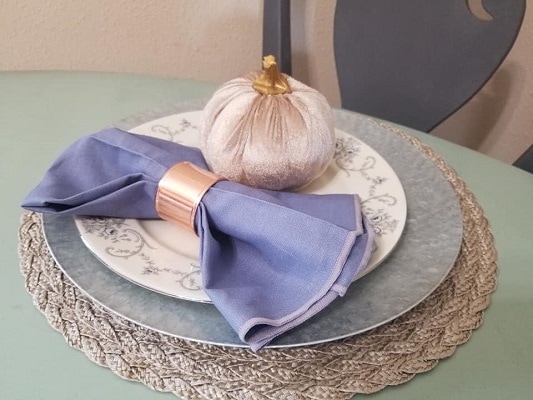 A Thanksgiving place setting with a mix of Dollar tree finds and china plates