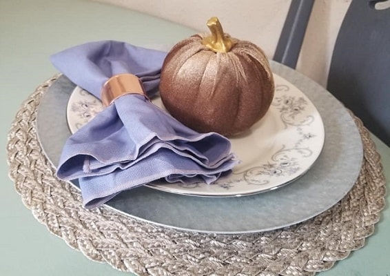 A Thanksgiving place setting with a mix of Dollar tree finds and china plates