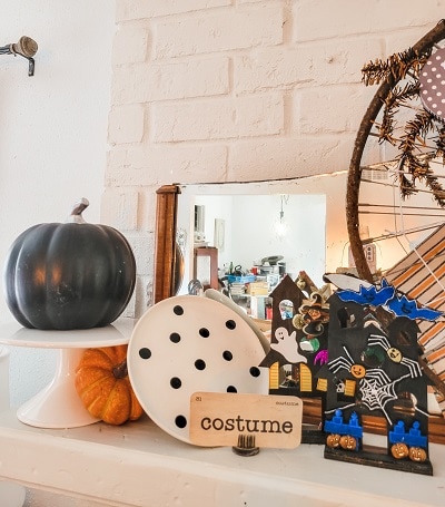 Classic white, orange and black Halloween mantel with pops of blue