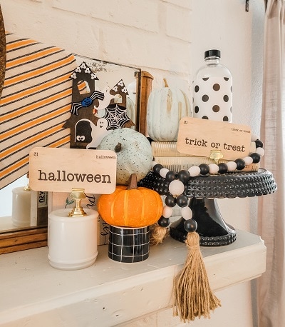 Classic white, orange and black Halloween mantel with pops of blue