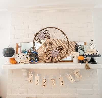 Classic white, orange and black Halloween mantel with pops of blue