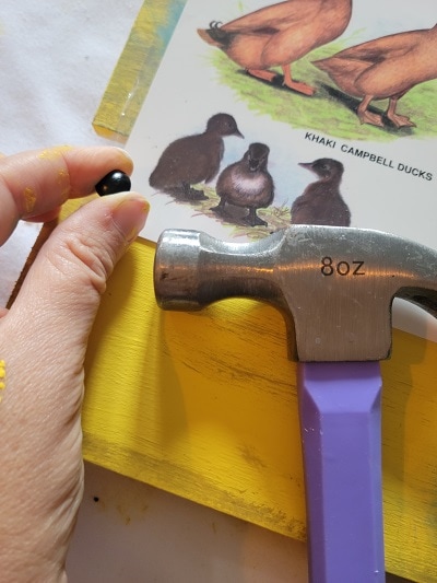 simple way to display a poster On a pallet with furniture nails with Dixie Belle's Terra Clay Paint