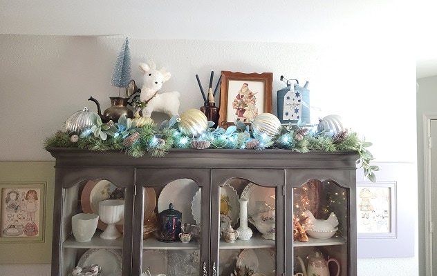 vintage Christmas china cabinet display with an old gas can, and DIY wooden tag