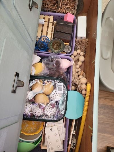 Decorative pieces stored in dresser drawers in small baskets