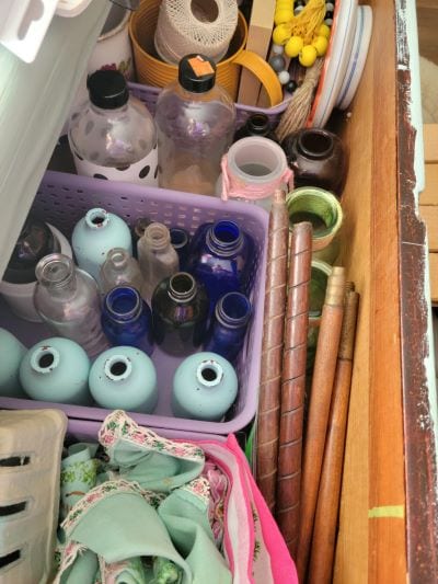 Decorative pieces stored in dresser drawers in small baskets