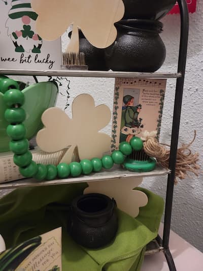 Green wood bead garland, a shamrock and an Irish lass vintage flash card.