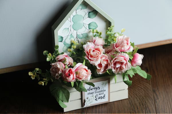 pink flowers in a house shaped box