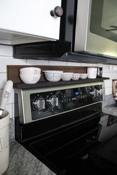 Shelf above stove with white bowls