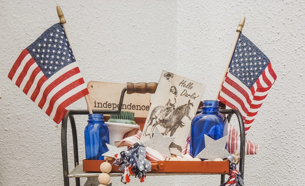 Fourth of July Tiered tray with vintage flash cards, ephemera, antique pieces and a wood bead garland for each season with fabrics tassels.