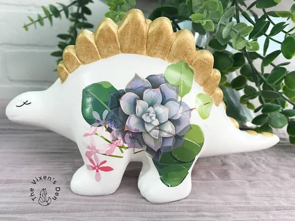 ceramic brontosaurus with succulent image and gold spines