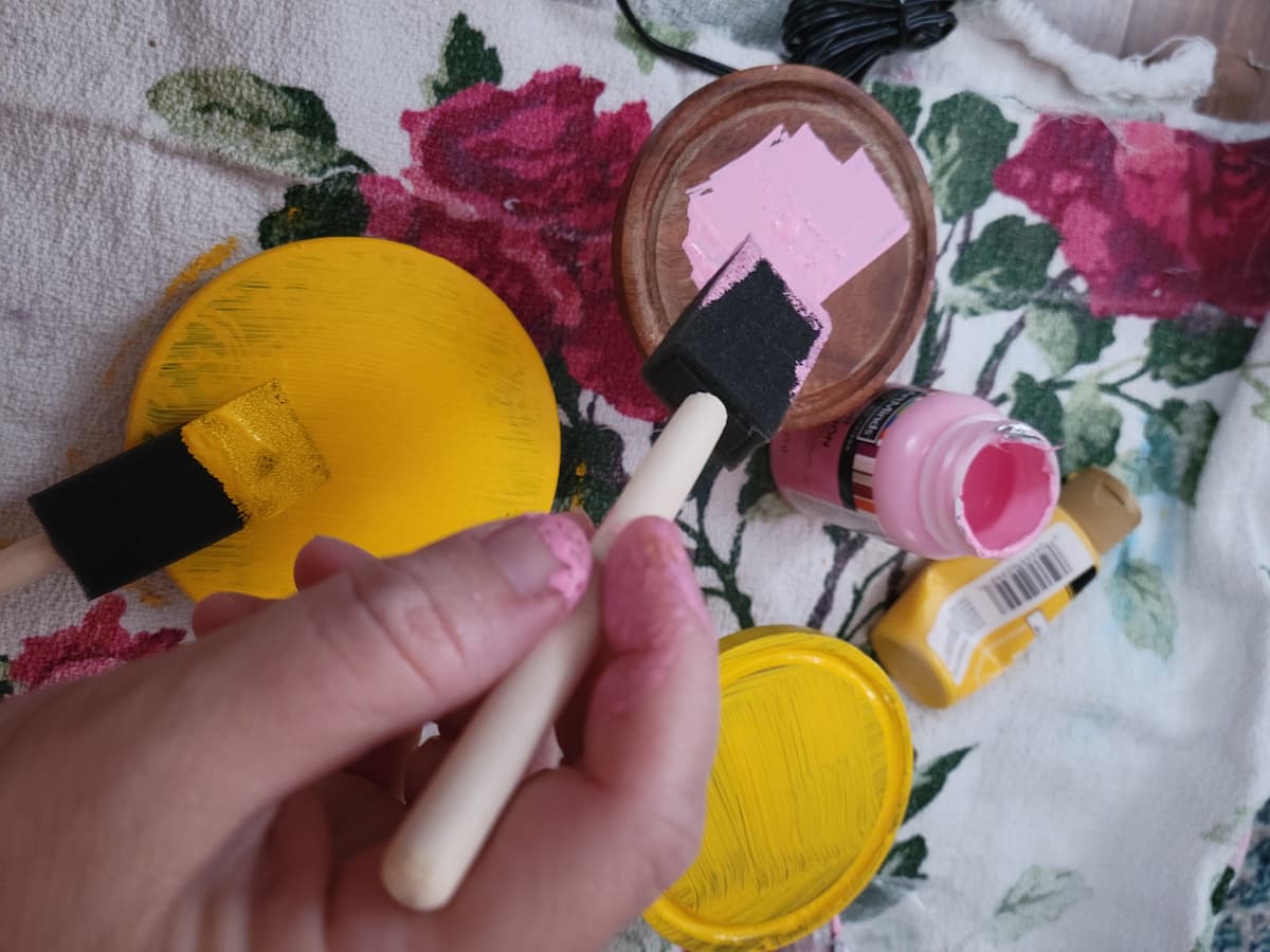 Painting coasters yellow and pink