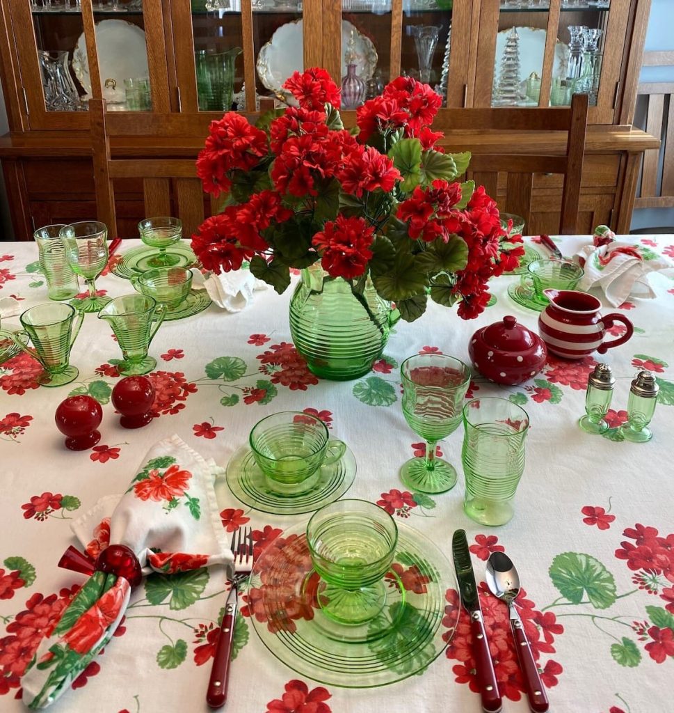red geranium and green glass table set up