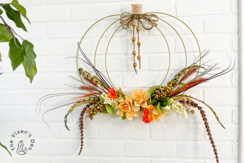 wire wreath with green, peach floral