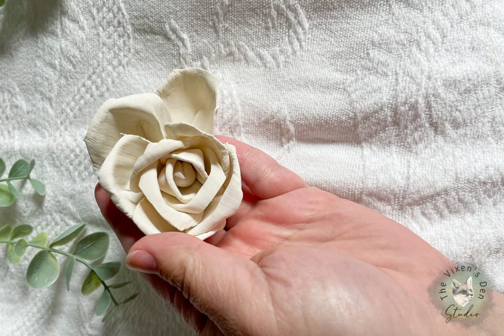 White wood flower in hand