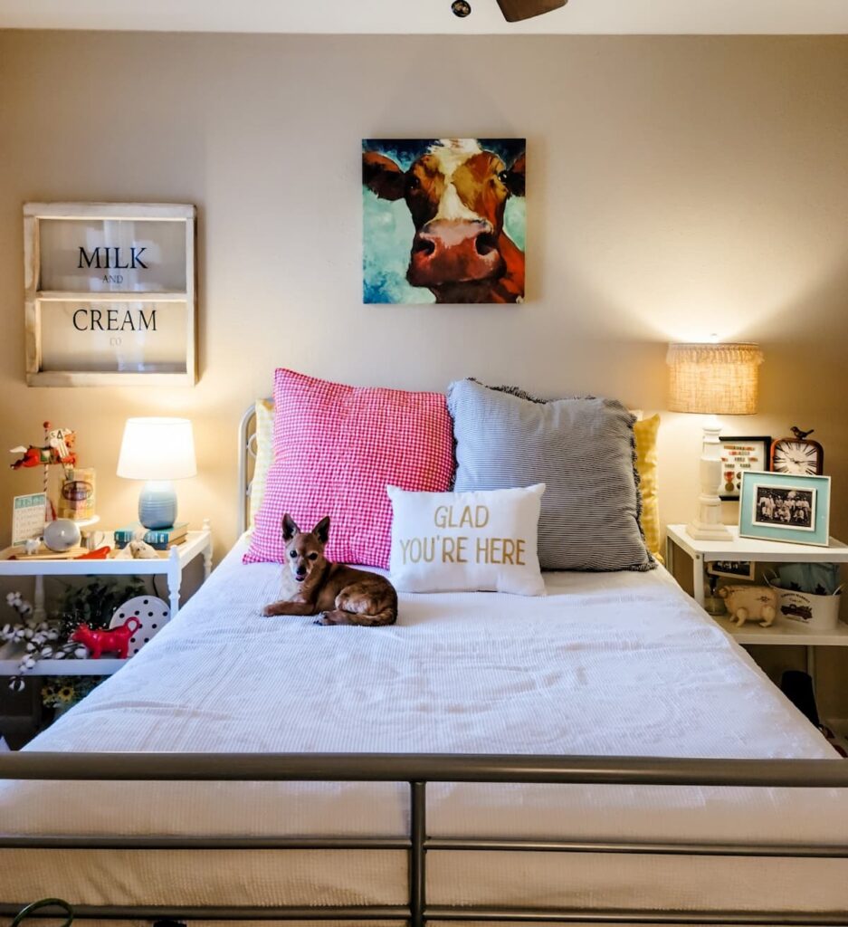 bed with side tables and cow print over