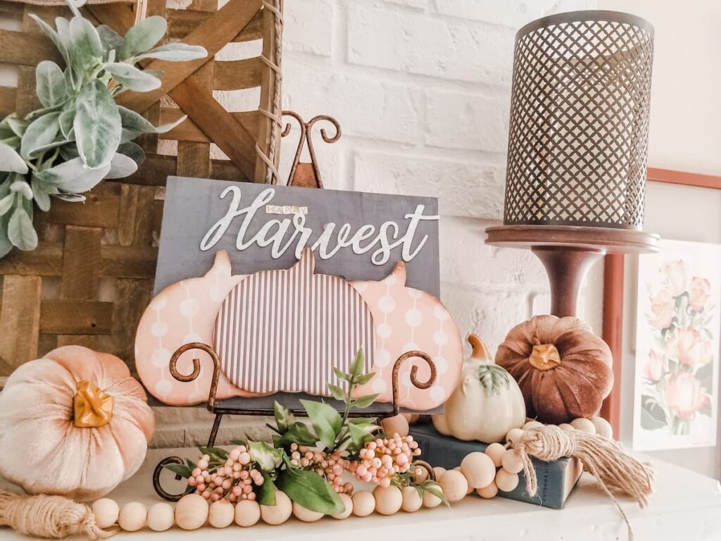 pink and grey harvest sign with candle holder bead garland and neutral pumpkins