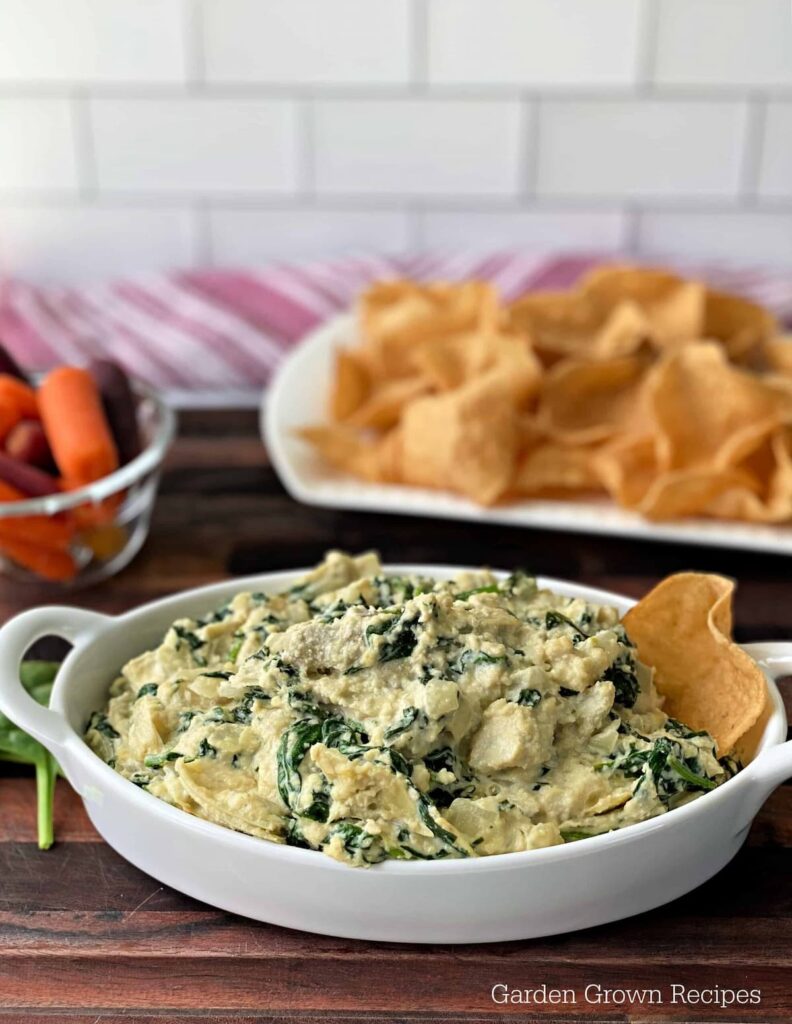 white dish with dip and tortilla chips