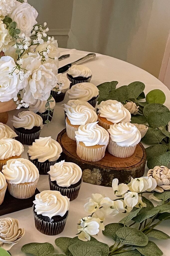 white iced cupcakes and flowers