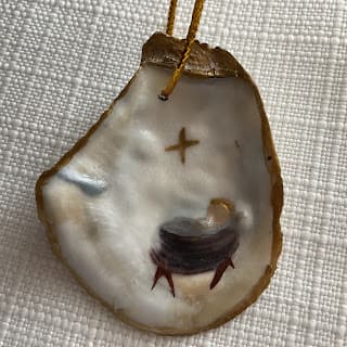 Oyster shell with baby Jesus in manger and star painted on it
