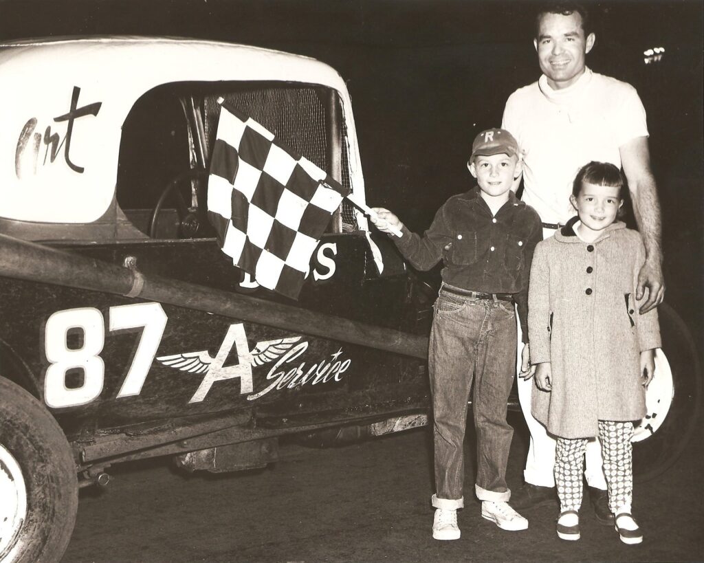 black and white racing photo with father and children