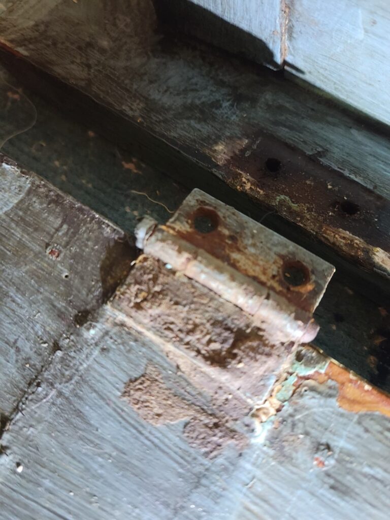 rusty hinge on blue table