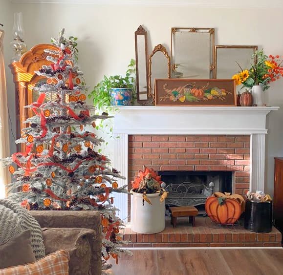 christmas tree with orange slices and a mantle