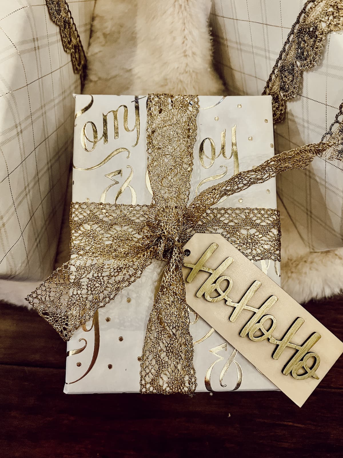 gift wrapped in white with gold ribbon and tag