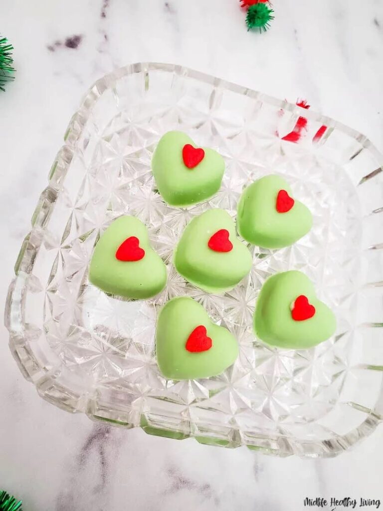 Green Heart shaped candy on glass plate