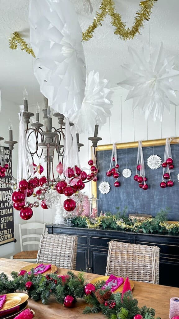 Dining table with ornaments hanging from chandelier