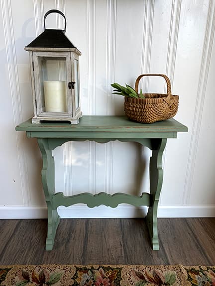 green table with lantern and basket