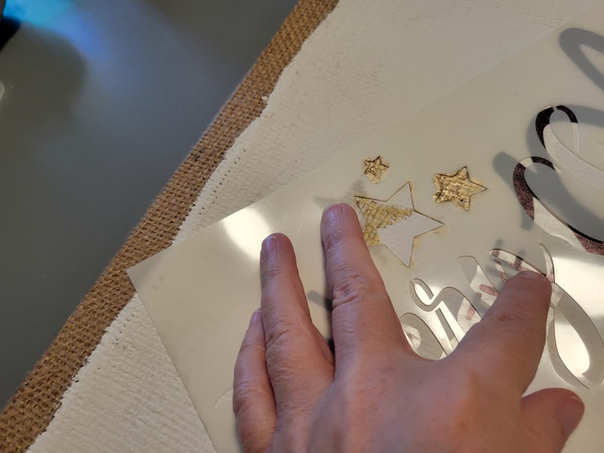Placing gold paint in star stencil