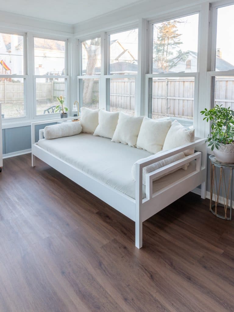 wood daybed on sun porch