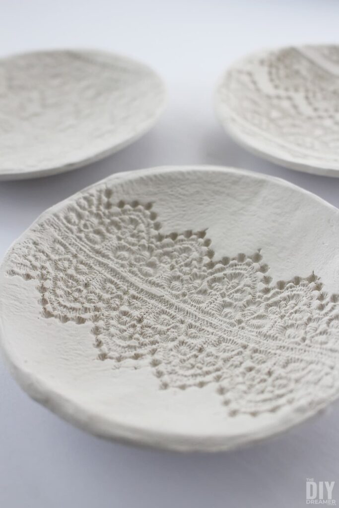 white clay bowl with lace design