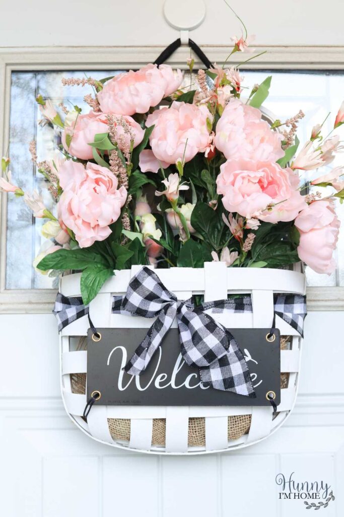 Basket of pink roses in basket with welcome sign