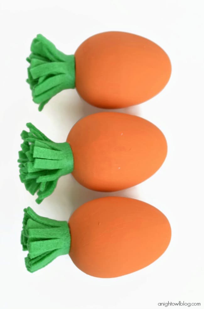 three wood egg carrots
