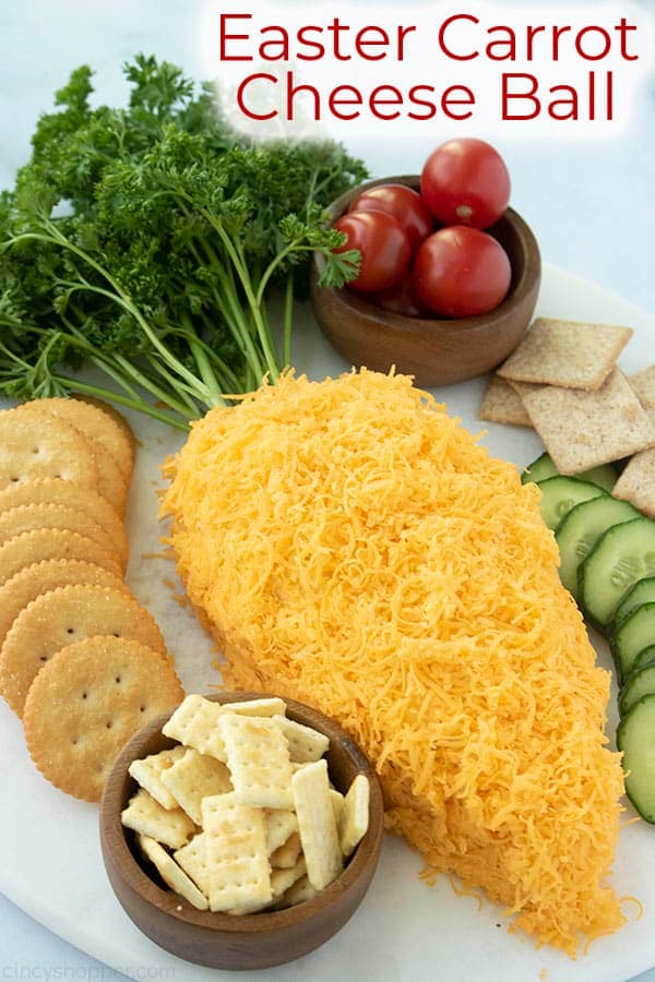 carrot shaped cheese ball with crackers and vegetables