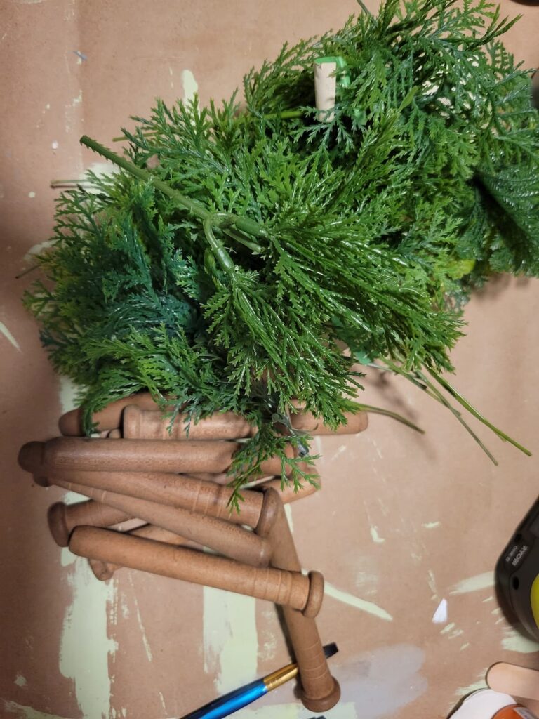 wood bobbins and greenery picks to make wood carrots