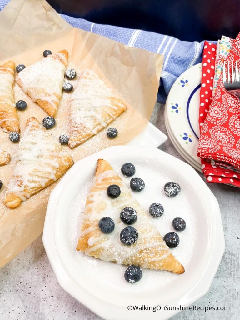 triangle pastry with blueberries on white plate
