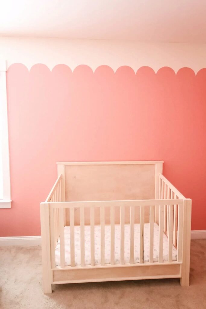 crib in pink room with scallops