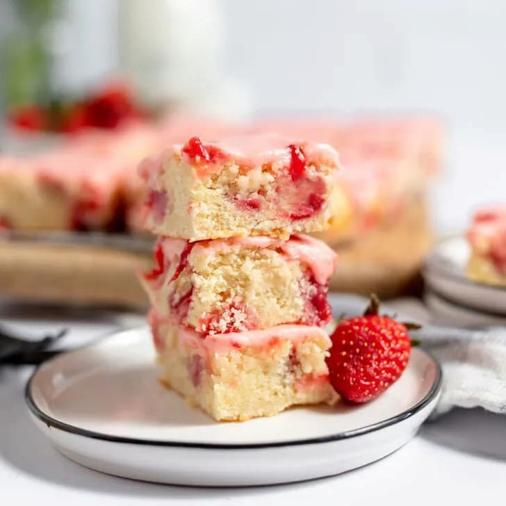 yellow cake with strawberry on white plate