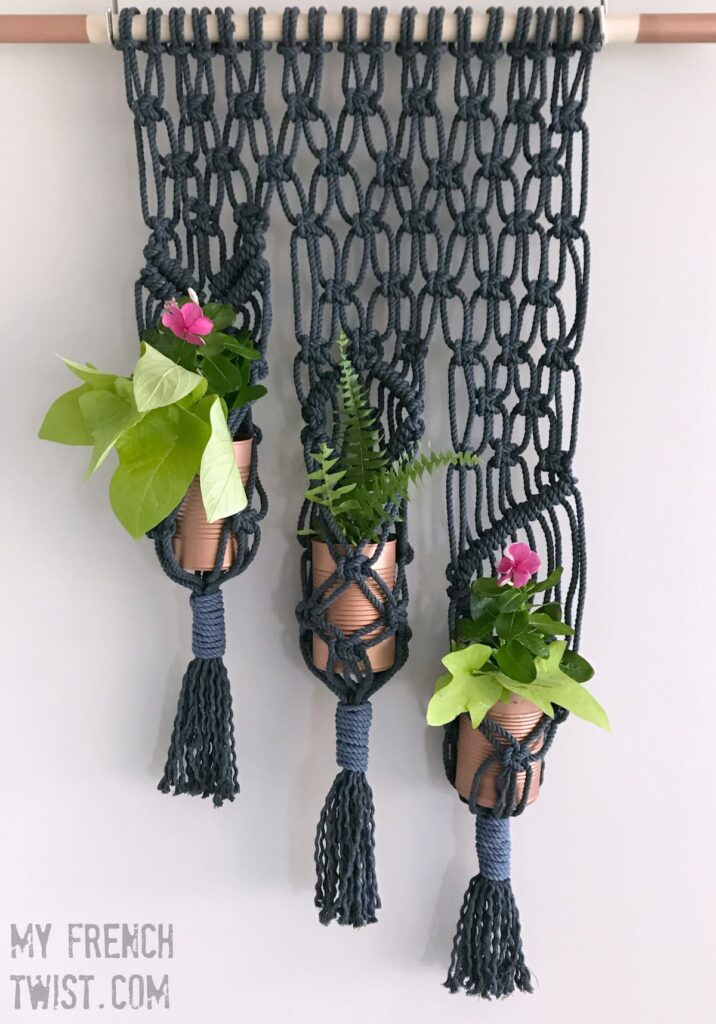 black macrame on wall with plants