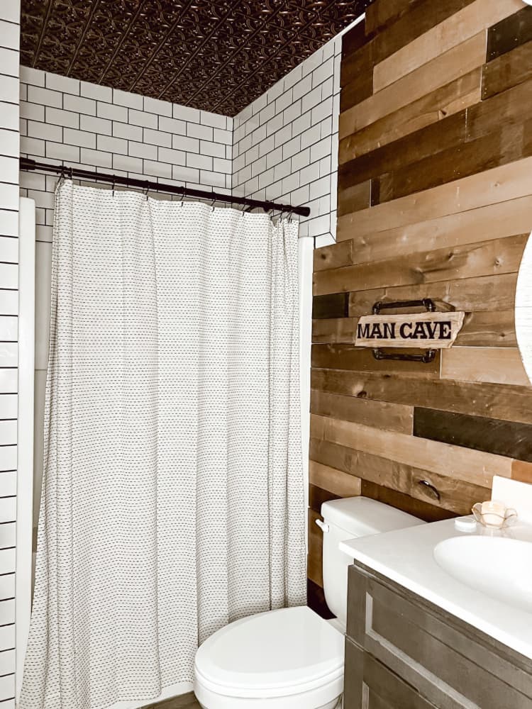 bathroom - shower curtain and wood walls