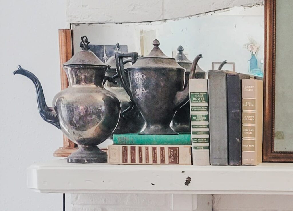 tarnished silver teapots on book stack