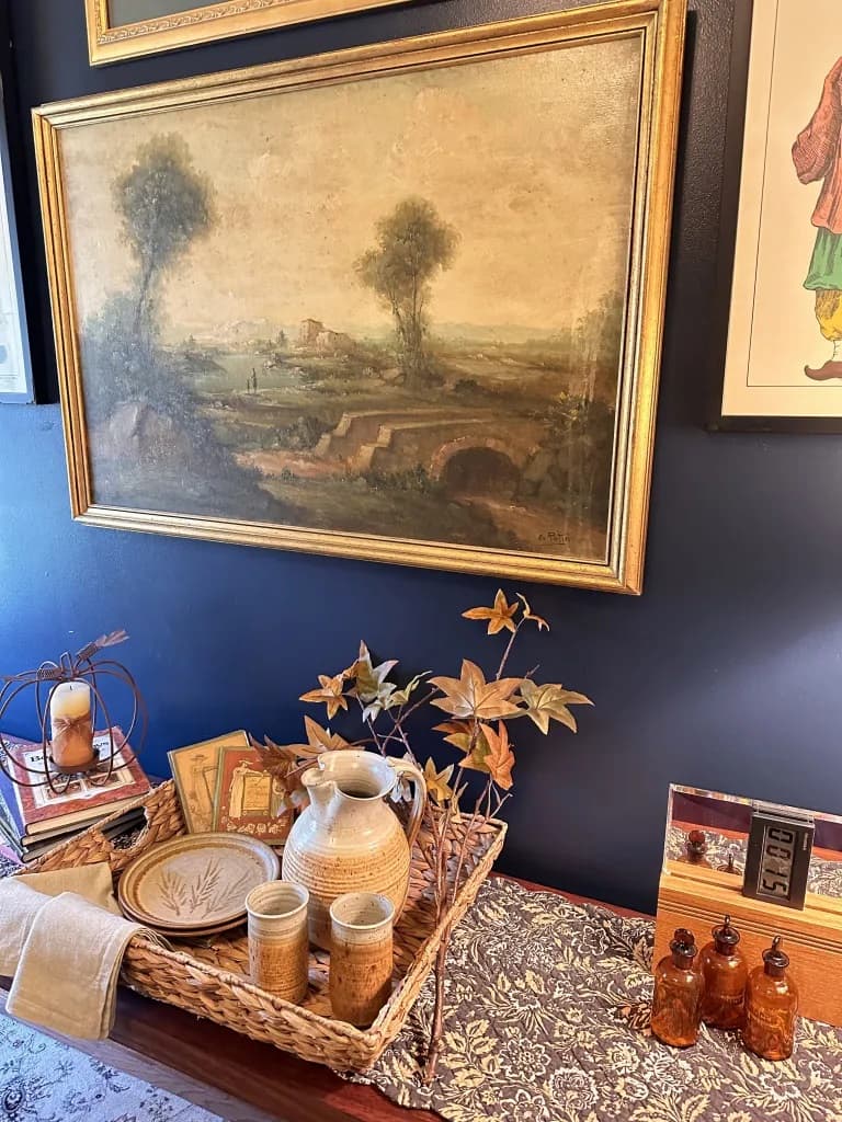 Framed painting on blue wall