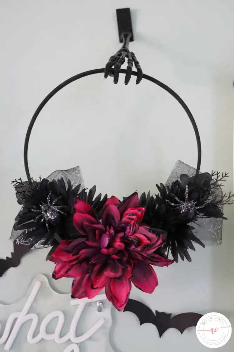 black wreath with red flower