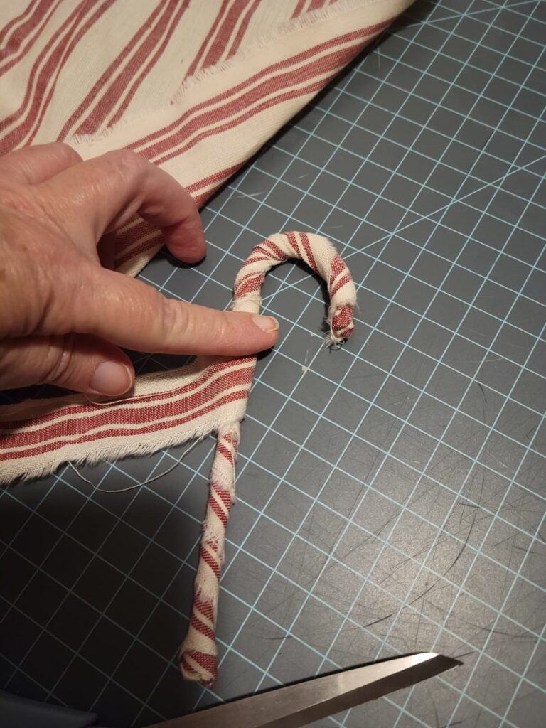 wrap red and white fabric around candy cane