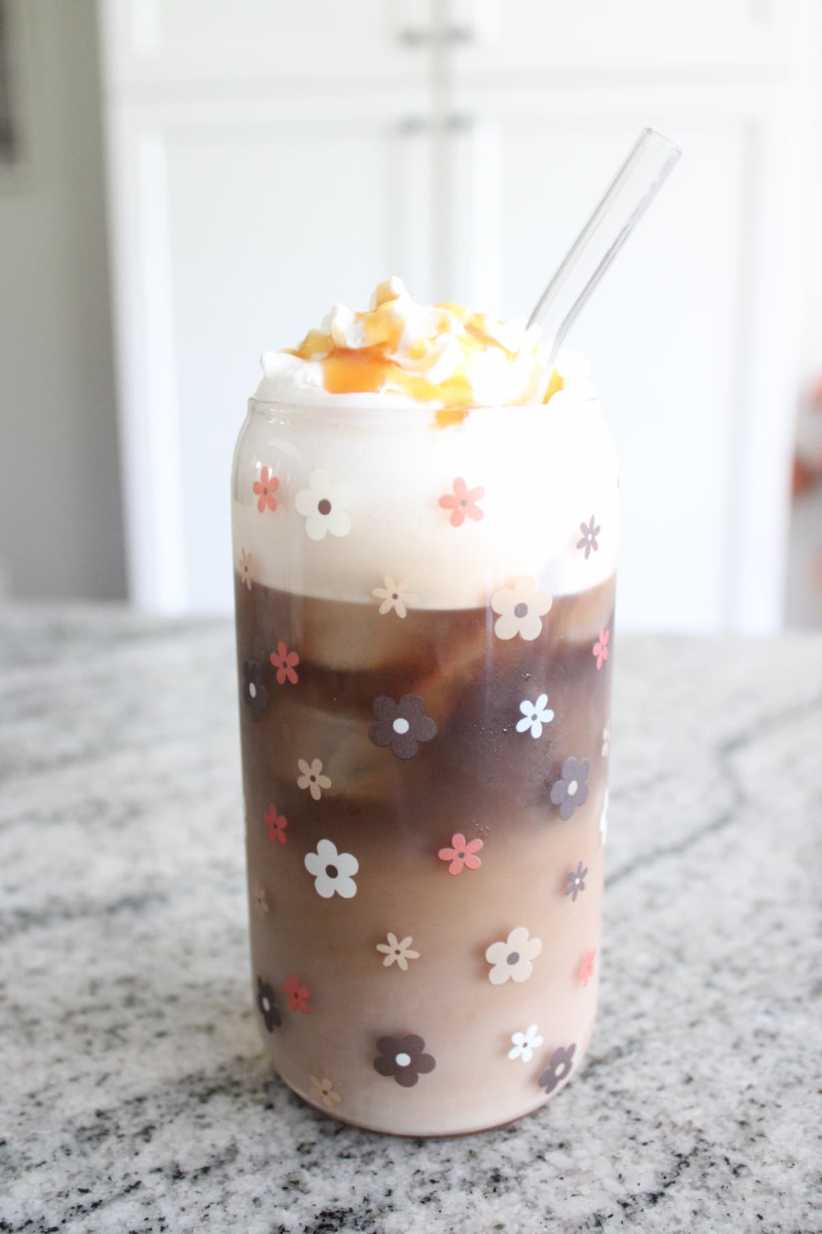 a glass with drink and whipped cream on top