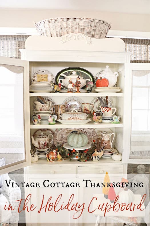 white cupboard of dishes and pumpkins