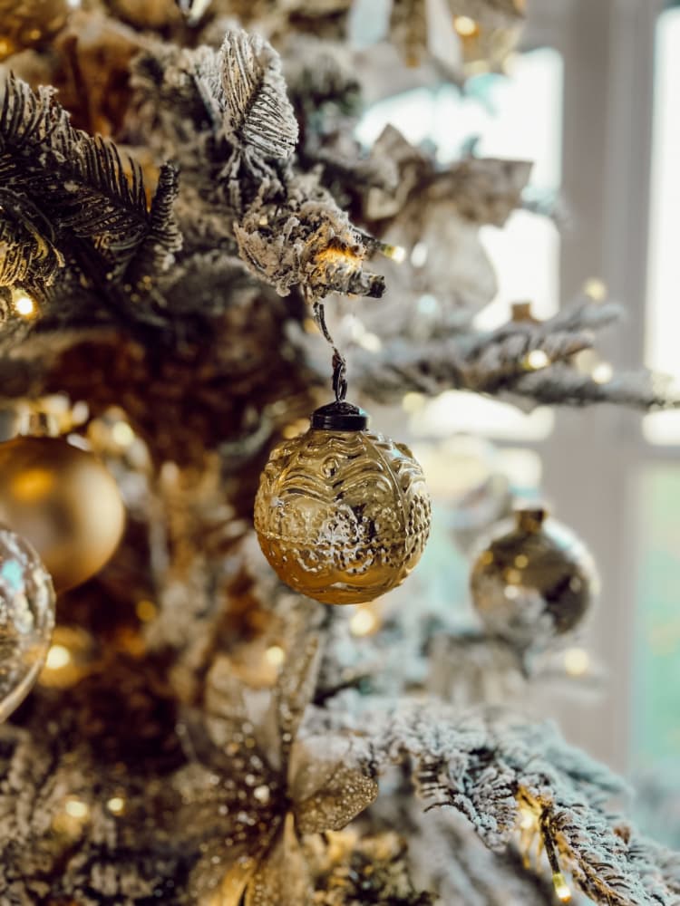 gold ornament on christmas tree